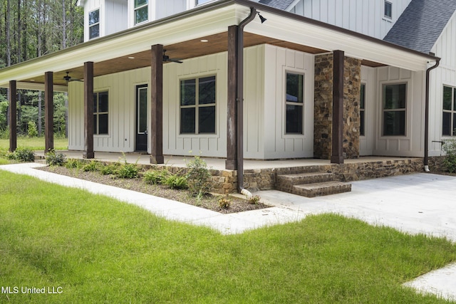 563 Valentine Rd, Holly Springs, MS 38635 - view of front of property with covered porch, ceiling fan, board and batten siding, a front lawn, and roof with shingles