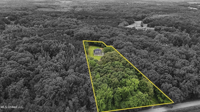 563 Valentine Rd, Holly Springs, MS 38635 - aerial view of property and surrounding area with property boundaries highlighted and a heavily wooded area