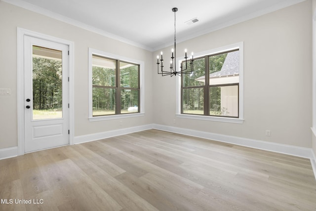 563 Valentine Rd, Holly Springs, MS 38635 - unfurnished dining area with a chandelier, light wood-type flooring, healthy amount of natural light, and ornamental molding