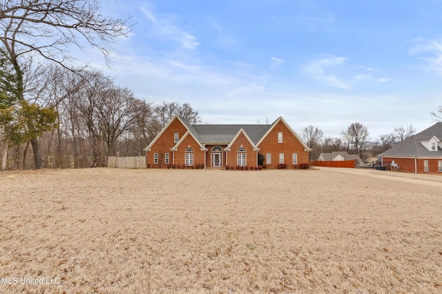 view of front of property with fence and brick siding