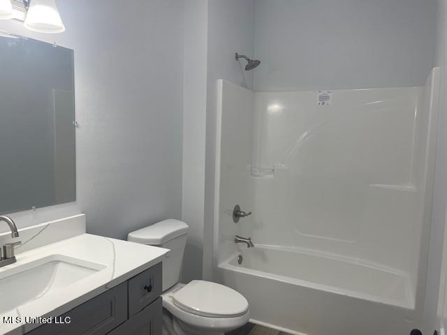 full bathroom with vanity, toilet, and washtub / shower combination