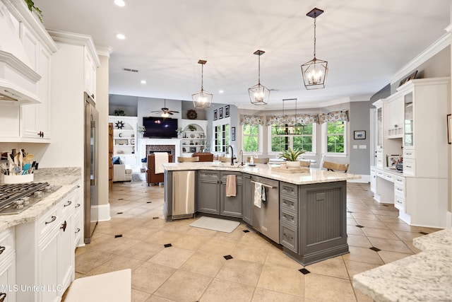 kitchen featuring gray cabinetry, stainless steel appliances, recessed lighting, open floor plan, and a sink