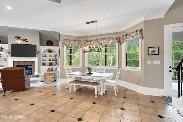 dining room with a chandelier, ornamental molding, light tile patterned floors, ceiling fan, and baseboards