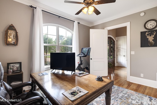 home office with ornamental molding, ceiling fan, wood finished floors, and baseboards