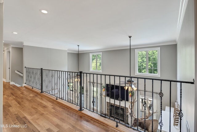corridor featuring wood finished floors, crown molding, recessed lighting, and baseboards