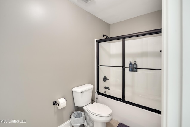 bathroom with bath / shower combo with glass door, baseboards, and toilet