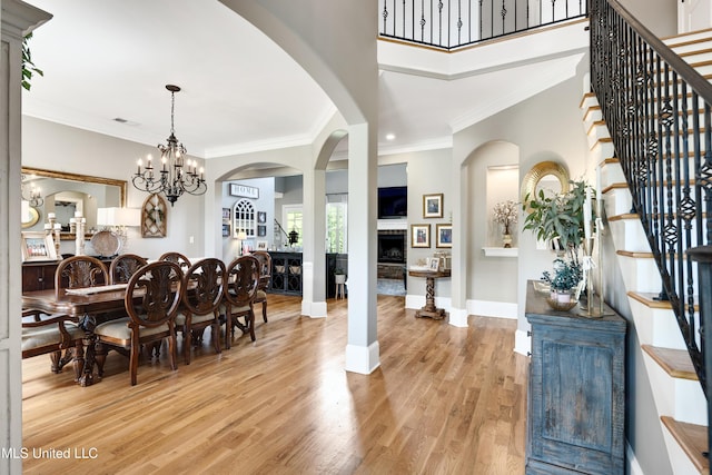 dining area featuring stairs, light wood finished floors, ornamental molding, baseboards, and recessed lighting