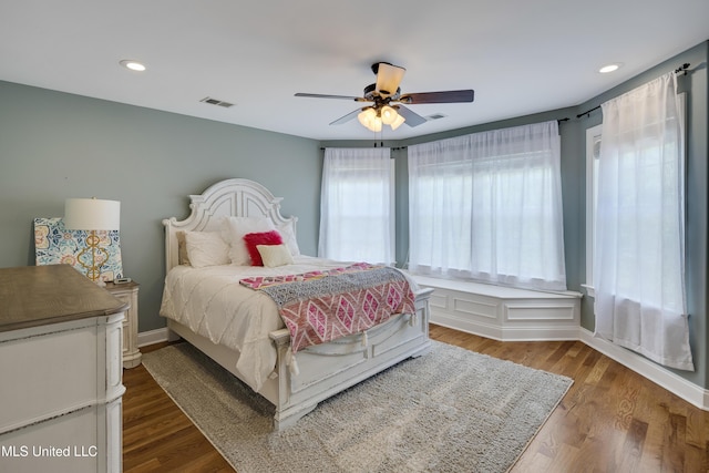 bedroom with ceiling fan, wood finished floors, baseboards, and recessed lighting