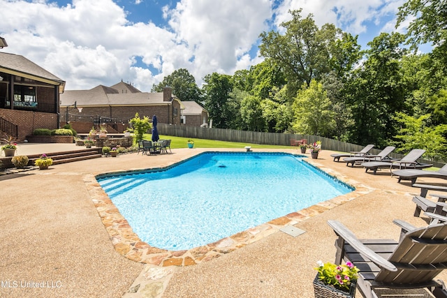 view of swimming pool with a patio and a fenced backyard
