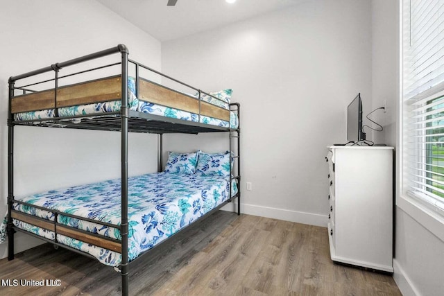 bedroom with hardwood / wood-style floors and ceiling fan