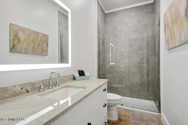 bathroom featuring walk in shower, hardwood / wood-style floors, vanity, and toilet