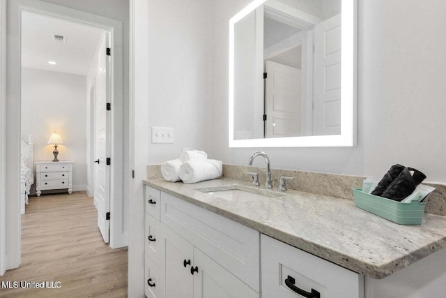 bathroom with vanity and hardwood / wood-style flooring