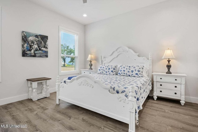 bedroom with hardwood / wood-style flooring and ceiling fan