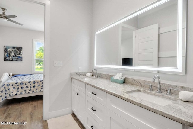 bathroom featuring hardwood / wood-style floors, ceiling fan, and vanity