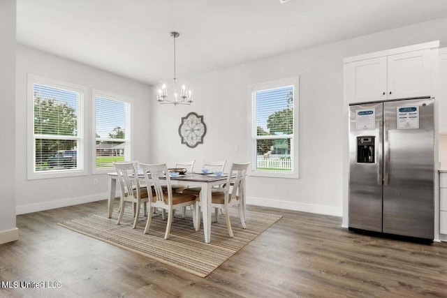 dining room featuring dark hardwood / wood-style floors, a wealth of natural light, and a notable chandelier