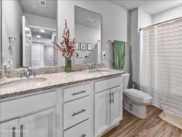 5065 Fairbury Way, Diberville, MS 39540 - full bath with wood finished floors, double vanity, toilet, and a shower with curtain