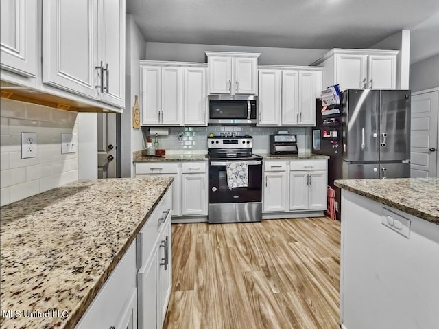 5065 Fairbury Way, Diberville, MS 39540 - kitchen with appliances with stainless steel finishes, tasteful backsplash, and white cabinets
