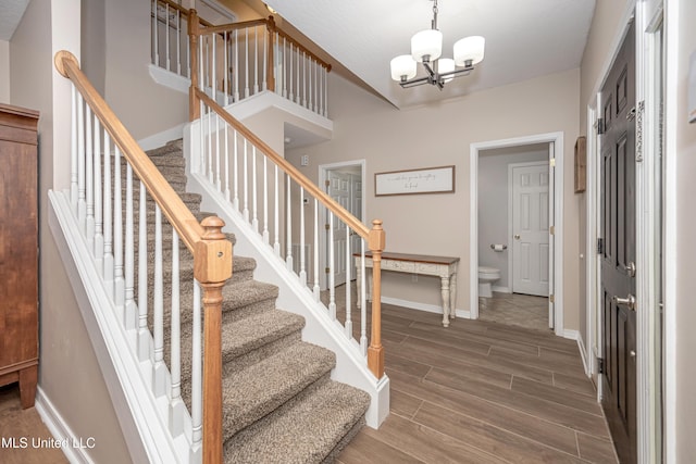 2204 Rue Beaux Chenes, Ocean Springs, MS 39564 - staircase featuring a chandelier and wood finished floors