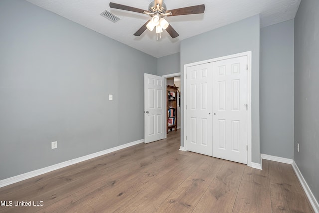 2204 Rue Beaux Chenes, Ocean Springs, MS 39564 - unfurnished bedroom featuring wood finished floors, a closet, and ceiling fan