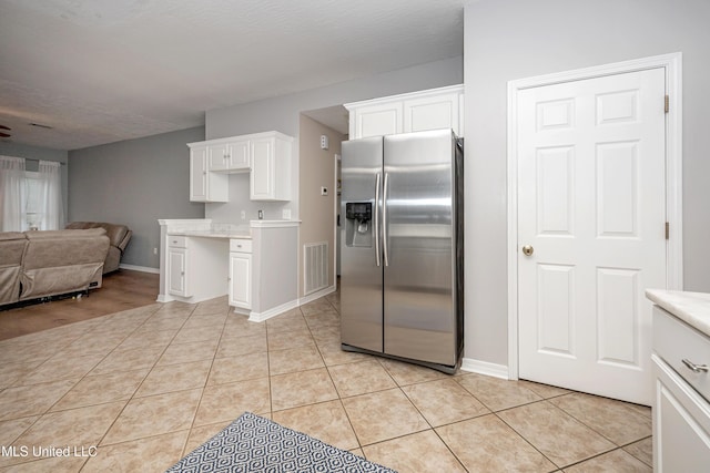 2204 Rue Beaux Chenes, Ocean Springs, MS 39564 - kitchen featuring stainless steel fridge with ice dispenser, light countertops, white cabinetry, and open floor plan