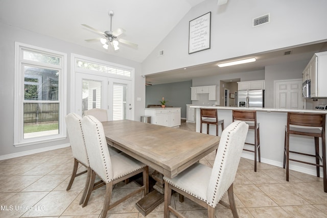 2204 Rue Beaux Chenes, Ocean Springs, MS 39564 - dining area featuring ceiling fan, healthy amount of natural light, light tile patterned flooring, and high vaulted ceiling