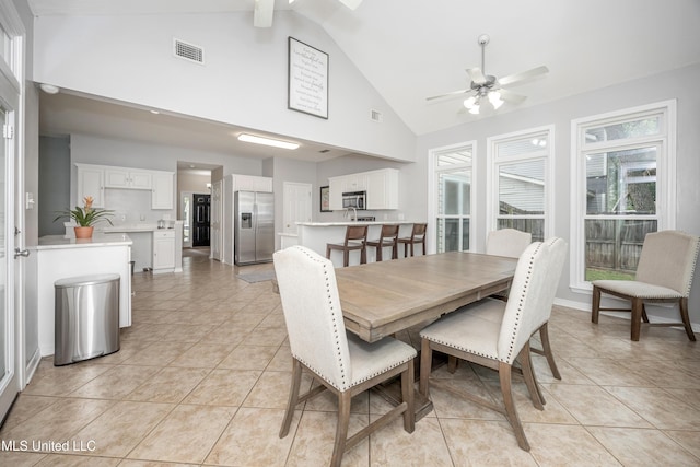 2204 Rue Beaux Chenes, Ocean Springs, MS 39564 - dining room featuring ceiling fan, light tile patterned floors, high vaulted ceiling, and healthy amount of natural light