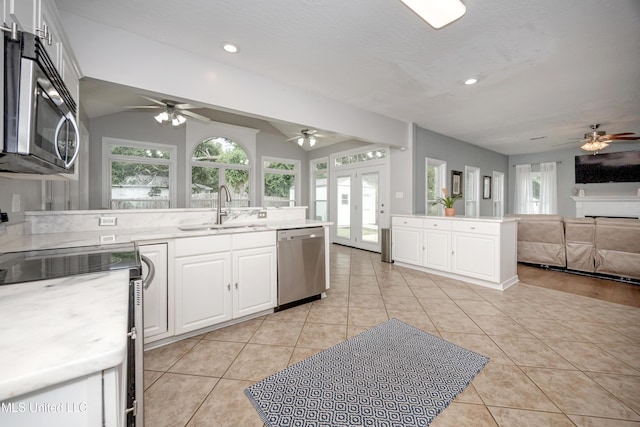 2204 Rue Beaux Chenes, Ocean Springs, MS 39564 - kitchen with appliances with stainless steel finishes, a ceiling fan, open floor plan, a peninsula, and vaulted ceiling