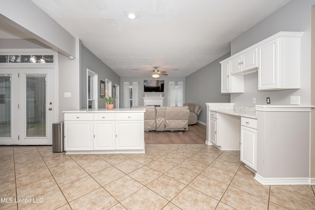 2204 Rue Beaux Chenes, Ocean Springs, MS 39564 - kitchen with a ceiling fan, light countertops, white cabinetry, light tile patterned floors, and open floor plan