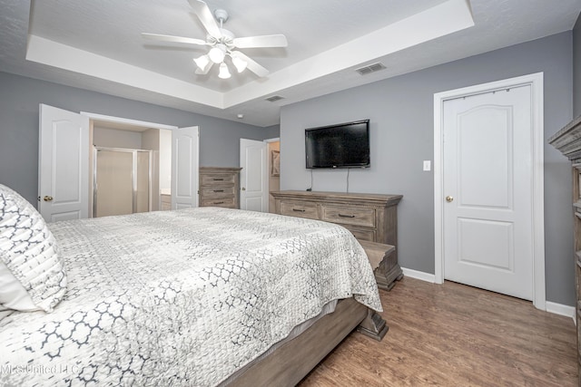 2204 Rue Beaux Chenes, Ocean Springs, MS 39564 - bedroom with a raised ceiling, wood finished floors, and ceiling fan