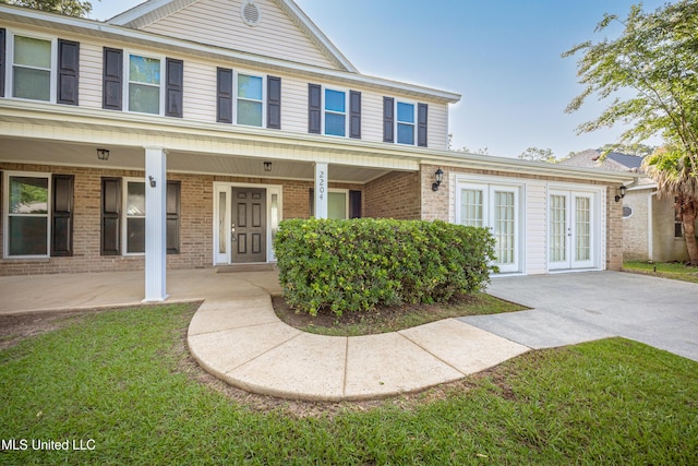 2204 Rue Beaux Chenes, Ocean Springs, MS 39564 - view of front of property featuring french doors and brick siding