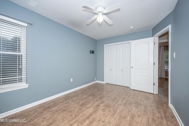 2204 Rue Beaux Chenes, Ocean Springs, MS 39564 - unfurnished bedroom featuring wood finished floors, a closet, and a ceiling fan