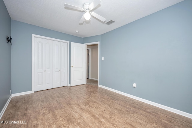 2204 Rue Beaux Chenes, Ocean Springs, MS 39564 - unfurnished bedroom with wood finished floors, a closet, and ceiling fan