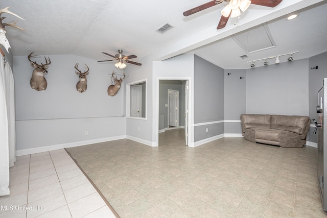 2204 Rue Beaux Chenes, Ocean Springs, MS 39564 - unfurnished living room featuring ceiling fan, vaulted ceiling, and attic access