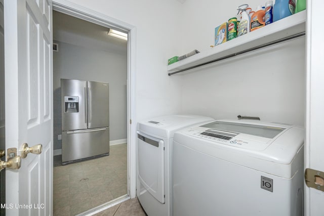 2204 Rue Beaux Chenes, Ocean Springs, MS 39564 - laundry room featuring independent washer and dryer and light tile patterned floors
