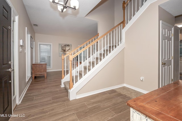 2204 Rue Beaux Chenes, Ocean Springs, MS 39564 - entrance foyer featuring a chandelier, stairs, and wood finished floors