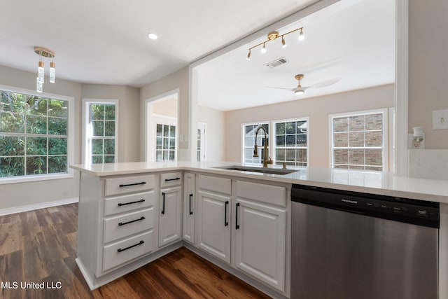 kitchen featuring kitchen peninsula, sink, stainless steel dishwasher, white cabinets, and dark hardwood / wood-style flooring