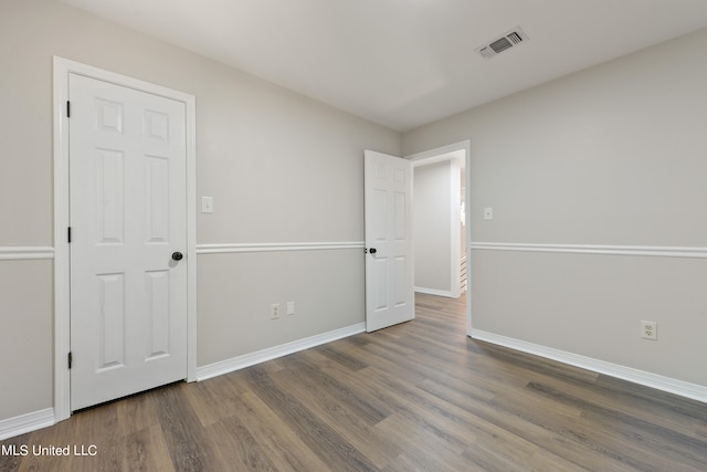 unfurnished bedroom with dark wood-type flooring