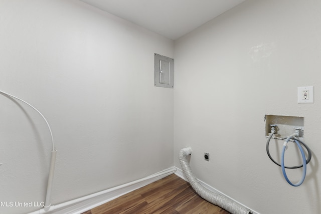 clothes washing area featuring electric panel, hardwood / wood-style floors, electric dryer hookup, and washer hookup