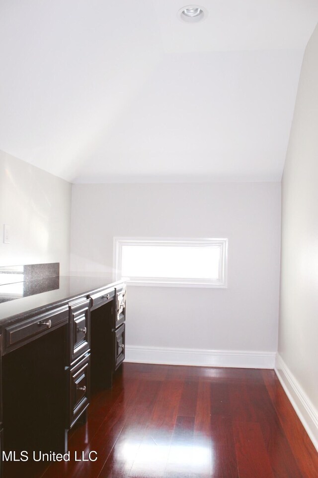 walk in closet with dark wood-type flooring