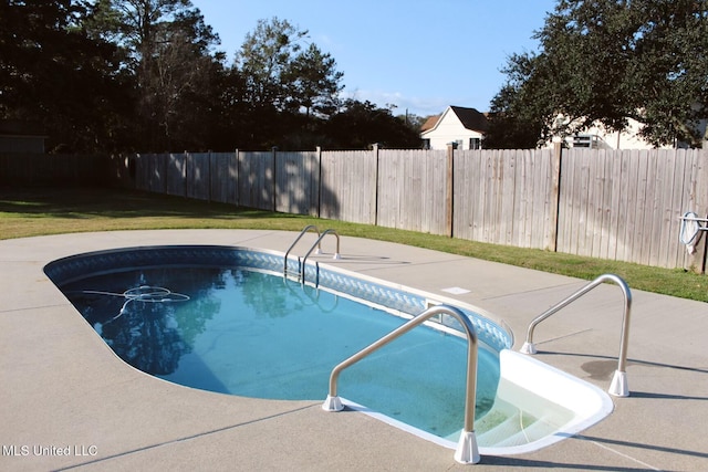 view of pool featuring a lawn