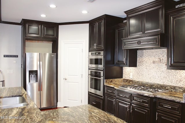 kitchen with stainless steel appliances, custom exhaust hood, dark stone countertops, and sink