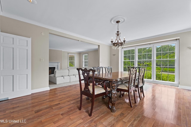 300 S 21st Ave, Hattiesburg, MS 39401 - dining area with crown molding, a chandelier, wood finished floors, healthy amount of natural light, and baseboards