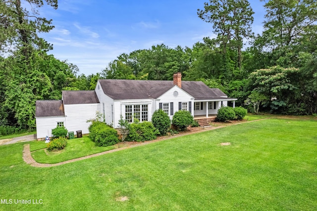 300 S 21st Ave, Hattiesburg, MS 39401 - view of front facade with a front lawn, a chimney, and a shingled roof
