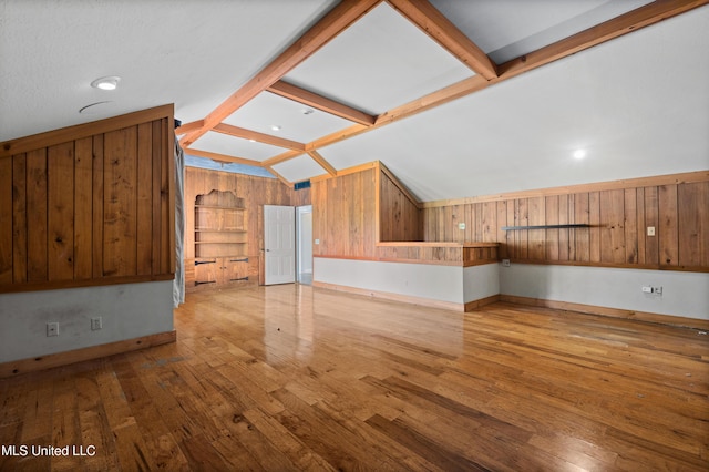 300 S 21st Ave, Hattiesburg, MS 39401 - unfurnished living room with hardwood / wood-style flooring, baseboards, and wooden walls