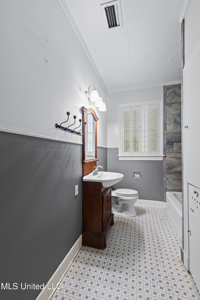 300 S 21st Ave, Hattiesburg, MS 39401 - bathroom with vanity, toilet, a tub, tile walls, and ornamental molding