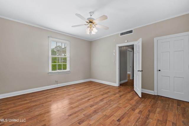 300 S 21st Ave, Hattiesburg, MS 39401 - unfurnished bedroom with ornamental molding, wood finished floors, baseboards, and a ceiling fan