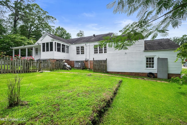300 S 21st Ave, Hattiesburg, MS 39401 - back of property with a sunroom, a shingled roof, and cooling unit