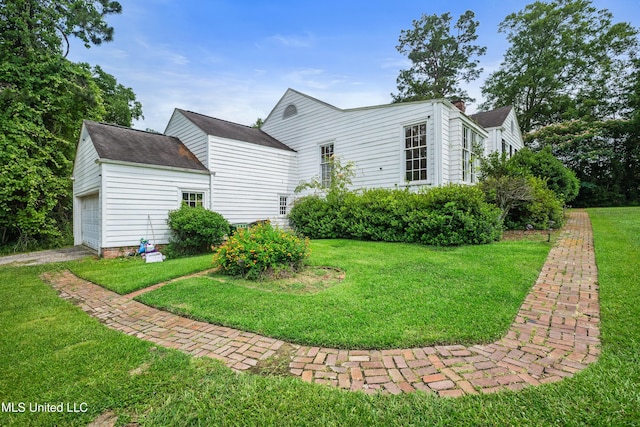 300 S 21st Ave, Hattiesburg, MS 39401 - view of side of home with a yard, a garage, and a shingled roof