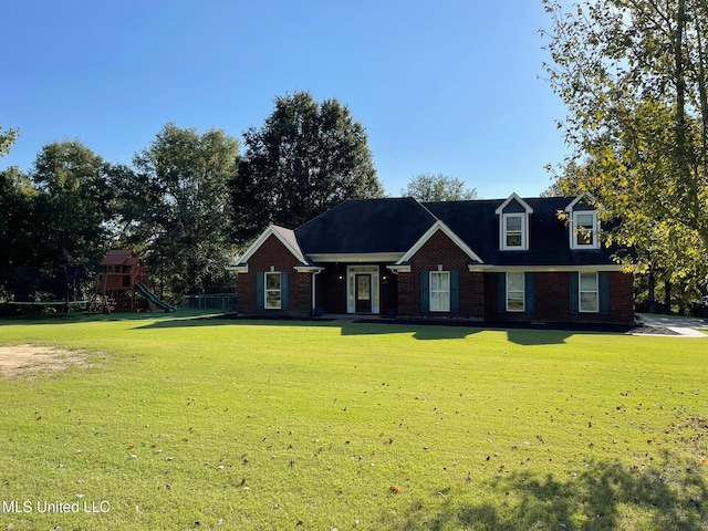 view of front of house featuring a front lawn and a playground