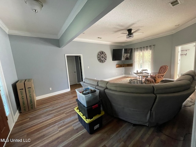 living room featuring dark hardwood / wood-style flooring, a textured ceiling, ornamental molding, and ceiling fan